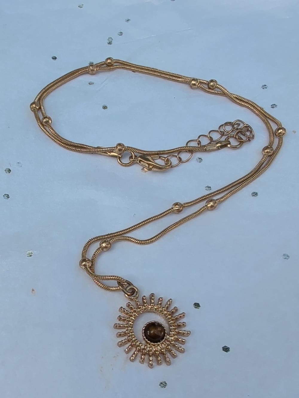 Gold Sunburst Pendant Necklace with Brown Stone